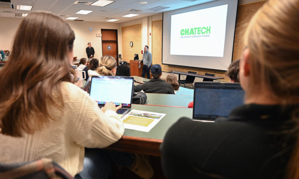 Students listen to presentations from various community organizations before deciding which clients to work with this semester.