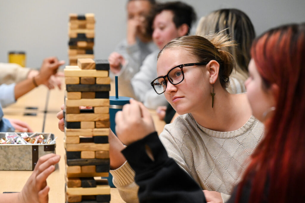 Students learn about client relations and production challenges by playing “Project Management Jenga.” Through gameplay they also learn collaboration, critical thinking, and creative problem-solving skills.