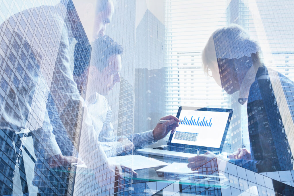 financial analytics, business team working on charts and big data on screen of computer, double exposure