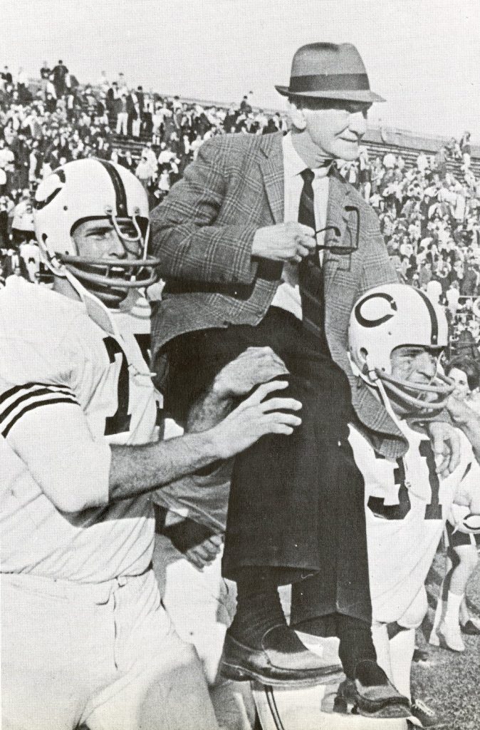 Coach A.C. "Scrappy" Moore being carried by football players