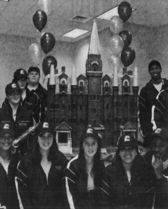 UTC Students with Founders Day cake in the shape of Old Main