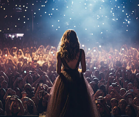 Back view of a beautiful female pop star singer giving music concert
