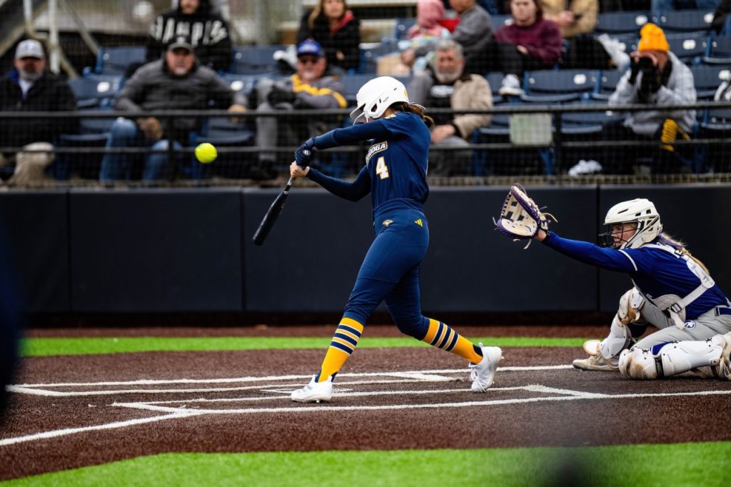 UTC Softball player #4 wearing dark blue jersey batting at Frost Stadium.