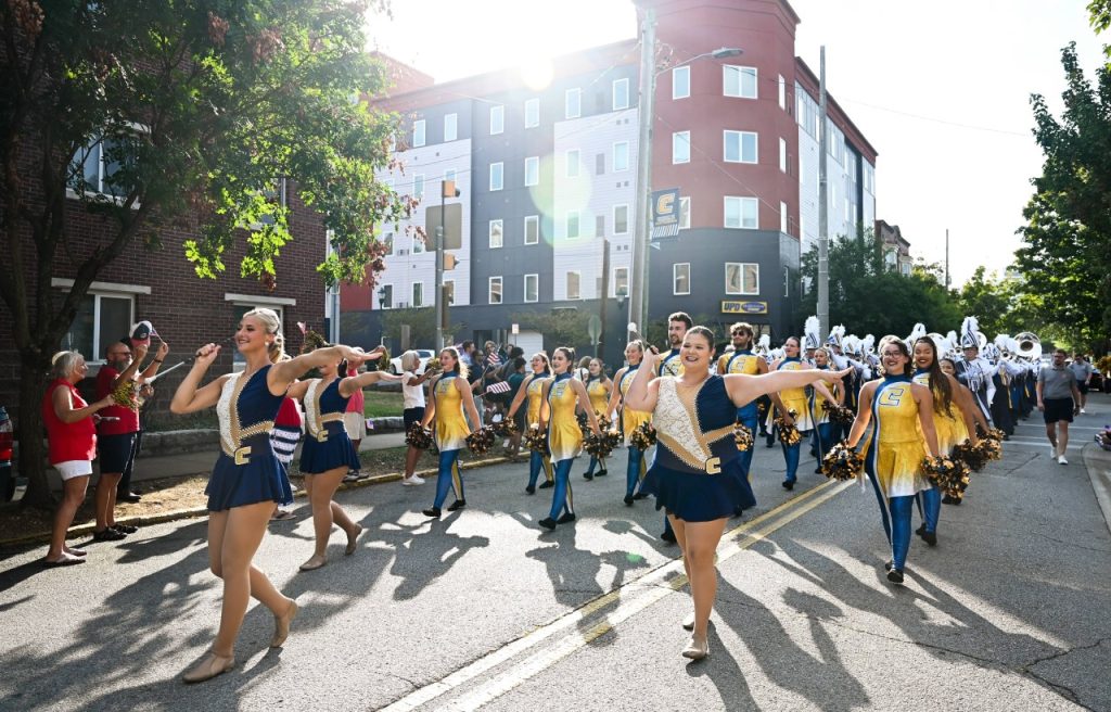 The marching mocs walk down vine street in the homecoming day parade