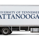 white moving truck with UTC logo on the trailer and the power c on the cab.