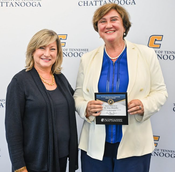 Irina Khmelko recieving an award symbolizing her 15 years of service at UTC