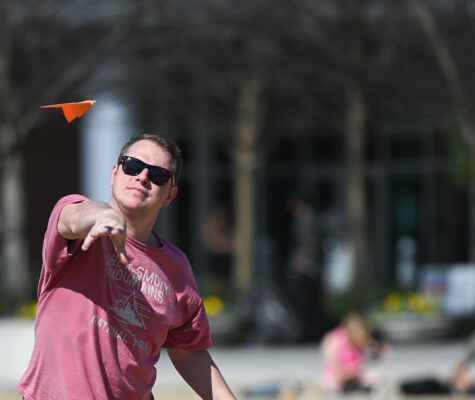 Man throwing paper airplane