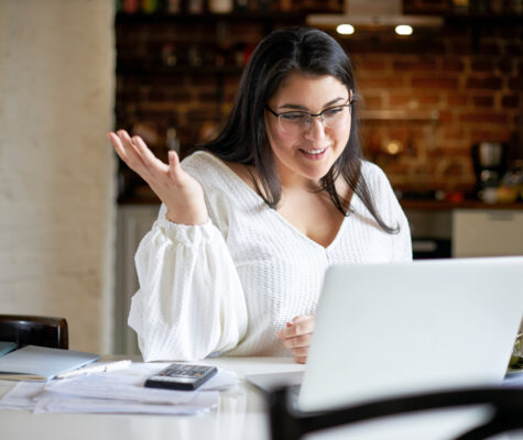 Portrait of charming young woman employee brainstorming with her colleague via group online chat using webcam on laptop computer. Image: shurkin_son/stock.adobe.com
