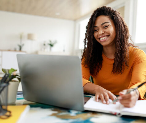 woman happily taking online class in her free time