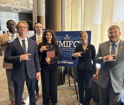 Students post next to SMIFC welcome sign