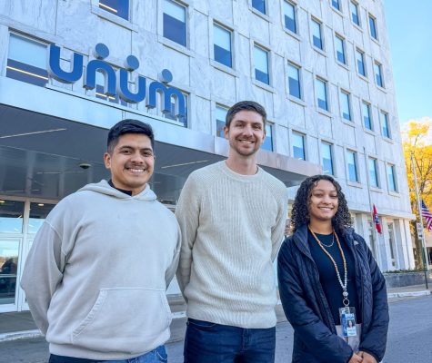 Unum scholars smile outside building