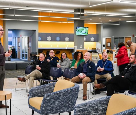 Robert Dooley speaks in front of a group of faculty and staff.
