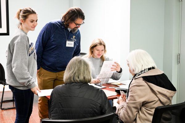 Accounting professor Steve Davenport helps students file taxes for community members