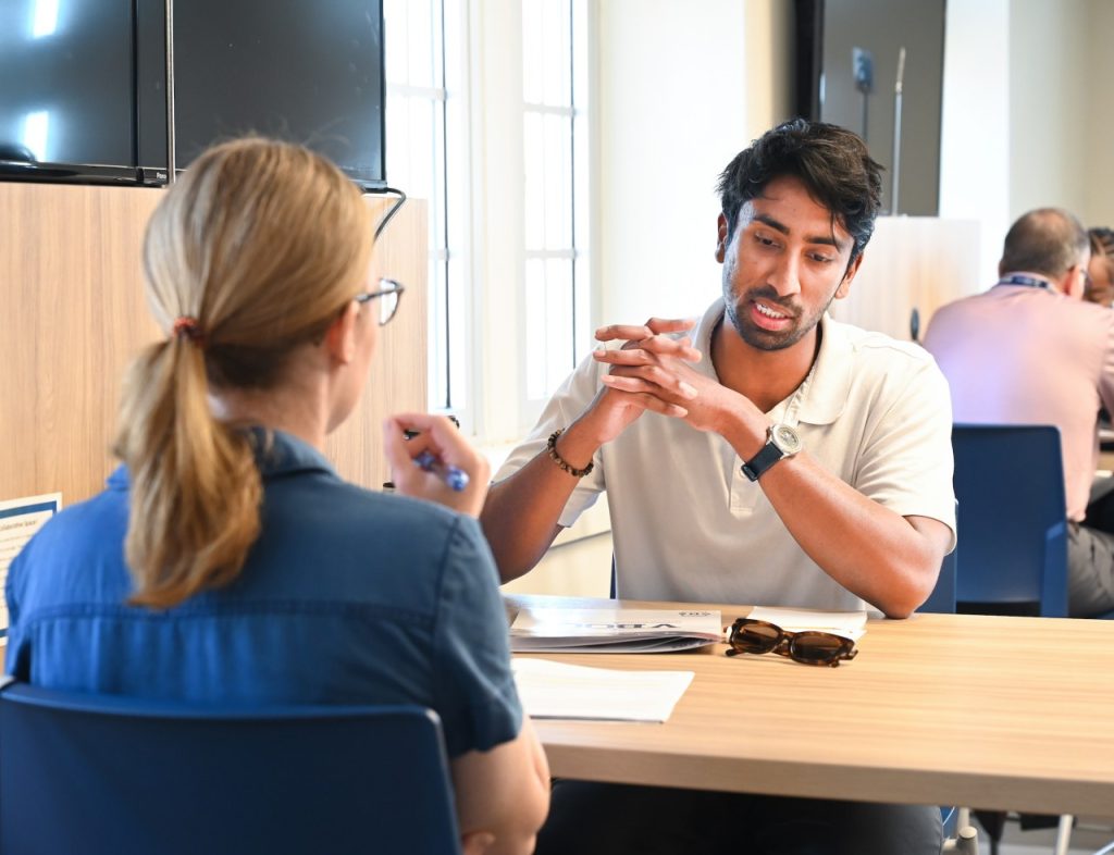 Two people talking at work.