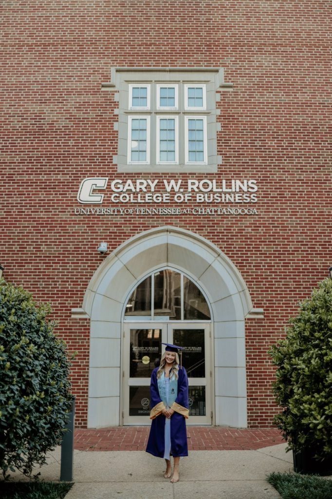 Krisitin Lyle poses in front of the Rollins College of Business on campus at UTC. 
