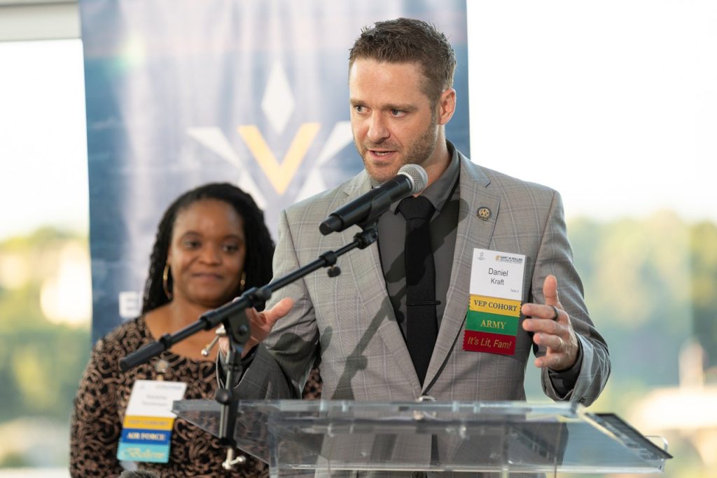 Person standing at a microphone giving a speach
