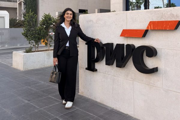 Bana Sulieman stands in front of the PWC building.