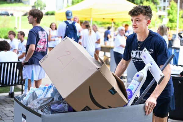 guy pushes cart full of boxes