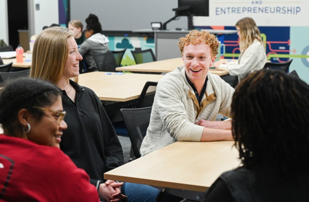 UTC Rollins College of Business student Graham Davis laughs with classmates during a UVI meeting in the Max Fuller Center for Innovation and Entrepreneurship.