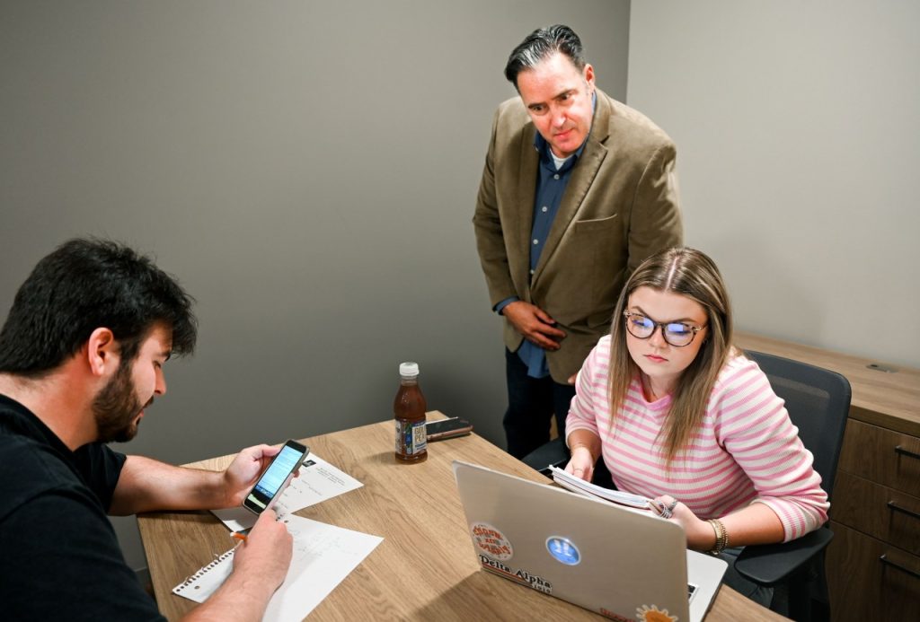 Sales Institute's Chris Plouffe mentors a students during a training session.