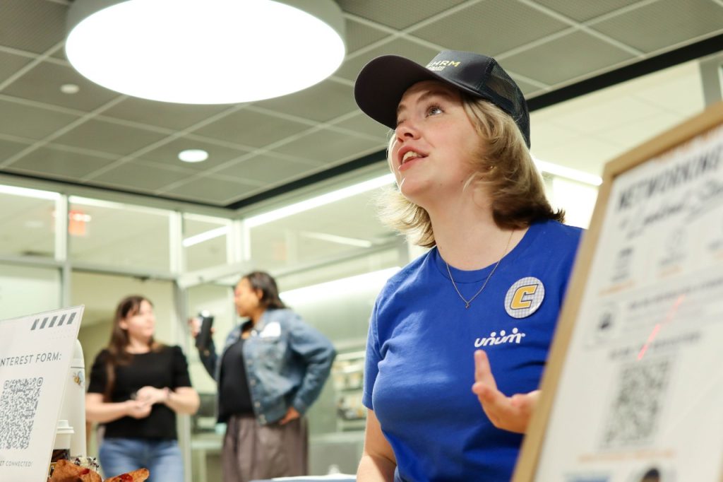A low angle shot of RCOB student promoting the SHRM Club to students. 