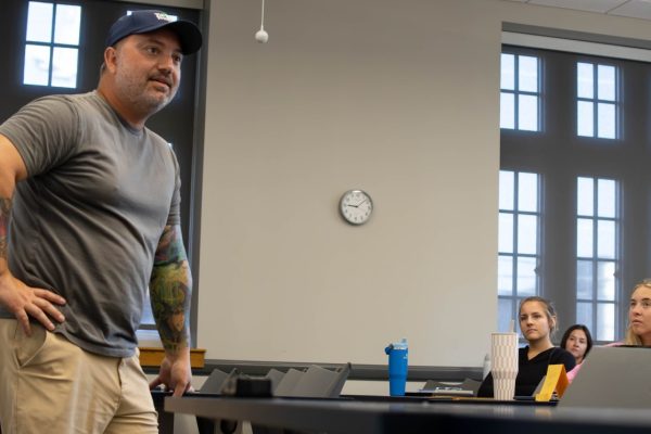 Cameron Parker stands in front of the class at RCOB as he talks about social media and content creation.