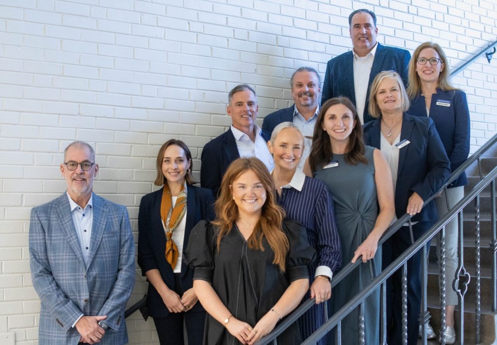 The John "Art" Phillips Sales Institute leadership stands for a photo along with Reliance Partners group.