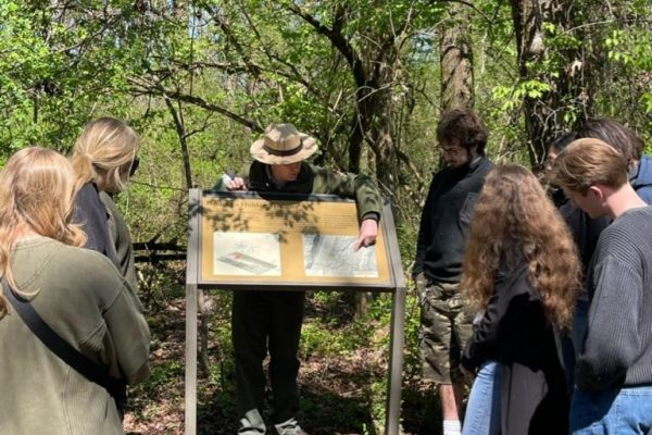 A photo of a park ranger giving a tour to students