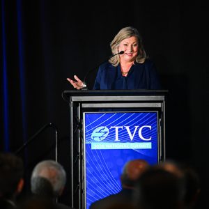 Chancellor Lori Mann Bruce stands behind a podium labeled TVC.