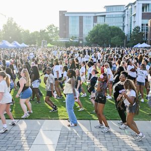 Students dancing on Chamberlain Field during the Oak Street Roast.