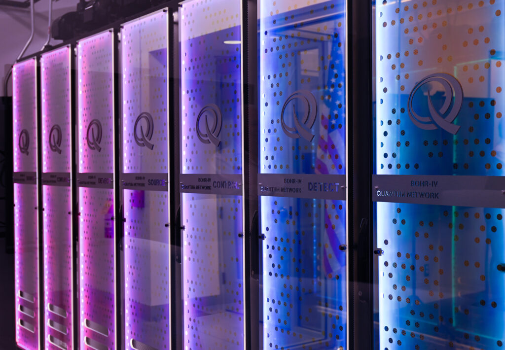 Blue and purple lights shine on the hardware of a quantum computing system.