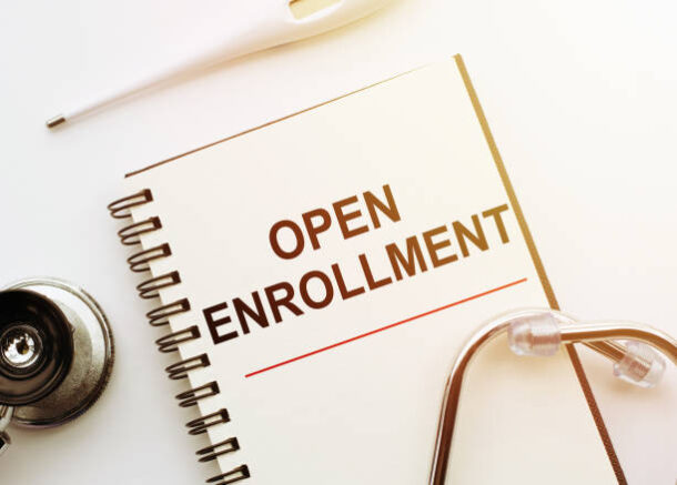 Open Enrollment - words written on notebook with stethoscope on white table, Medical Concept