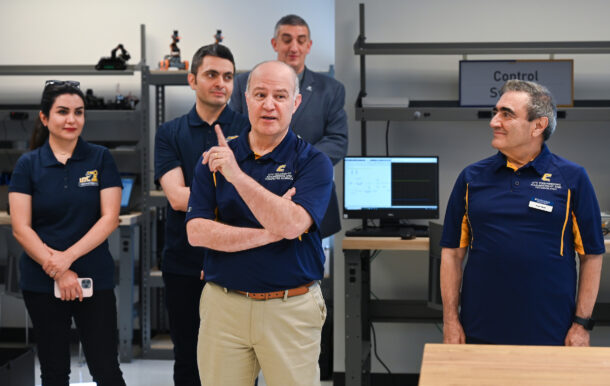 Dr. Ahad Nasab, center, speaks at the grand opening of the Robotics, Intelligent Systems and Control Lab.