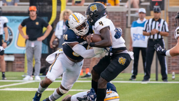 Jay Person, left, tackles Kennesaw State's Jonathan Murphy (photo courtesy of Derek Daniel/GoMocs.com)