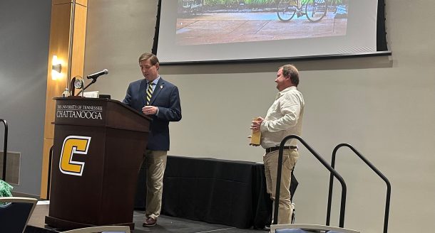 Graduate School Interim Dean Ethan Carver presents the Outstanding Community Partner Award to Anesthesiology Consultants Exchange's Scott Monterde.