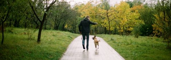 man walking his dog in the park