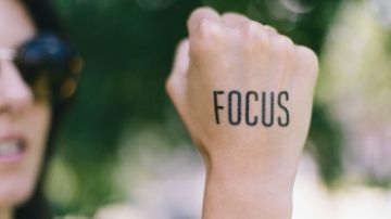 the word focus written on a woman's hand