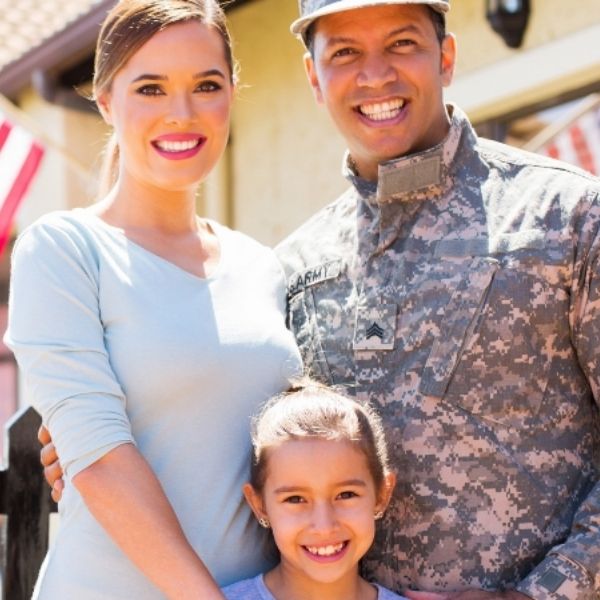 military family in front of a flag