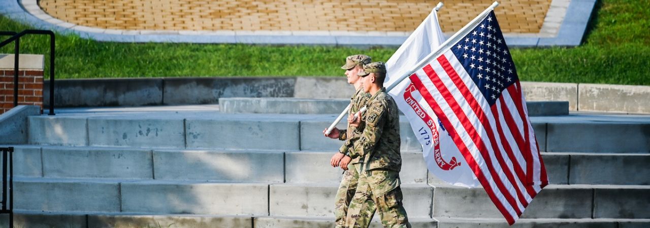 two soldiers carrying flags