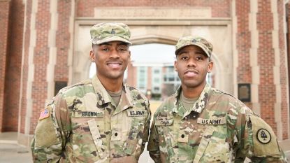 two military men in uniform looking at camera