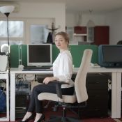 a businesswoman sitting perfectly straight at her office space