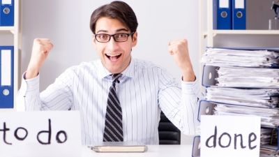 man happy with no papers in his to do pile and all of his papers in his done pile