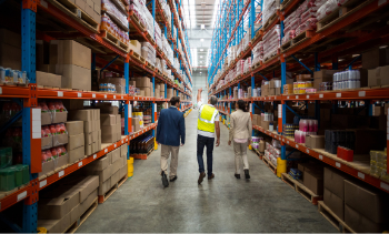 supply chain management walking through warehouse