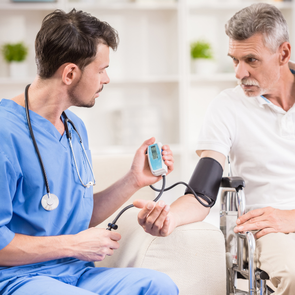 male nurse checking a patient's blood pressure