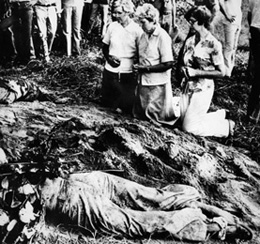 Nuns pray over the American nuns killed by a military death squad in El Salvador, December 2, 1980.