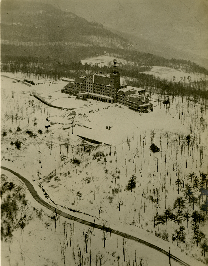 Black-and-white aerial photograph of the Lookout Mountain Hotel with snow on the ground, located in Lookout Mountain, Georgia, near Chattanooga, Tennessee. The building is now Carter Hall and the signature building of the Covenant College campus. Photographed by Herman Lamb circa 1935.