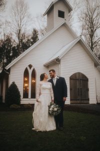 Newlyweds standing outside a chapel