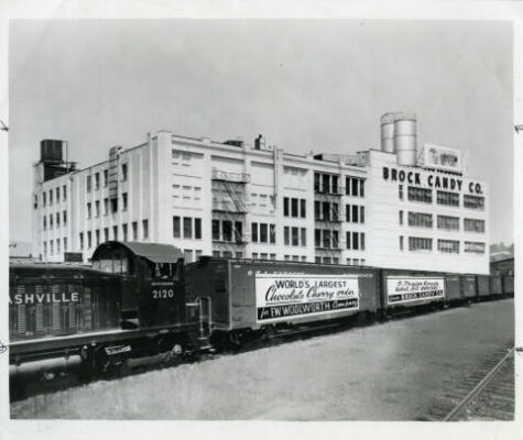 Train freight cars in front of the Brock Candy factory