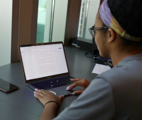 Student wearing a headband using a laptop to study.