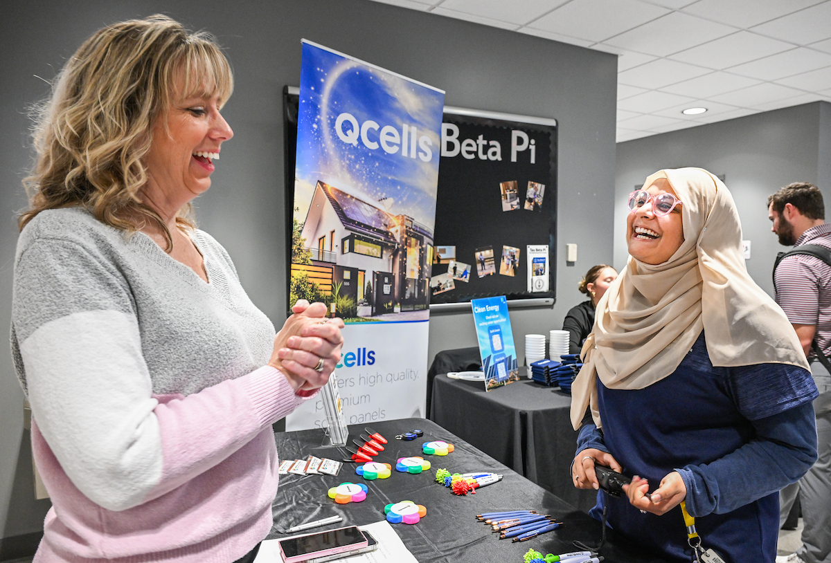 Tooba Tanveer is laughing with a recruiter during the CECS Career Fair. 